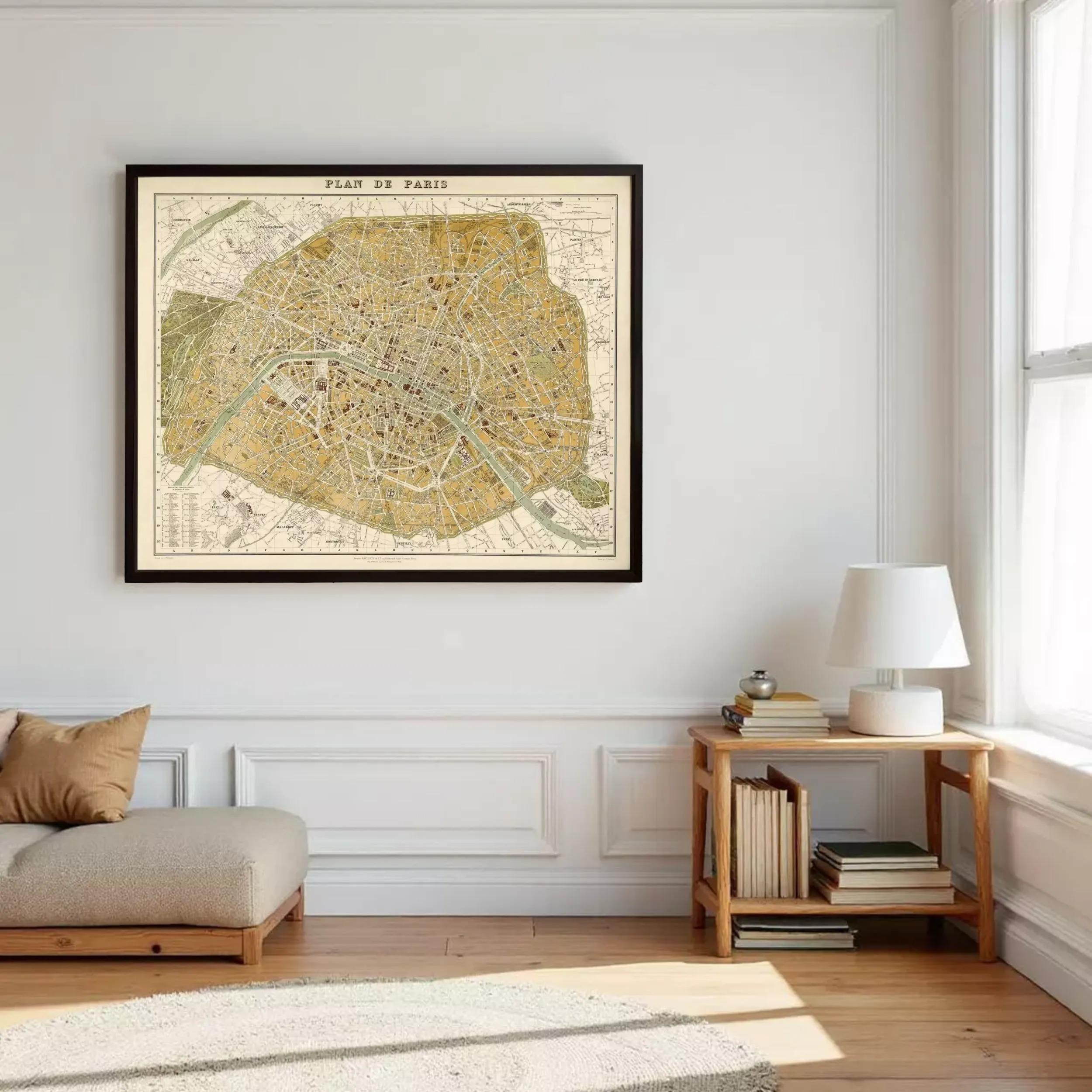 a large framed map of Paris hanging on a white wall, with a wooden side table and a lamp next to it.