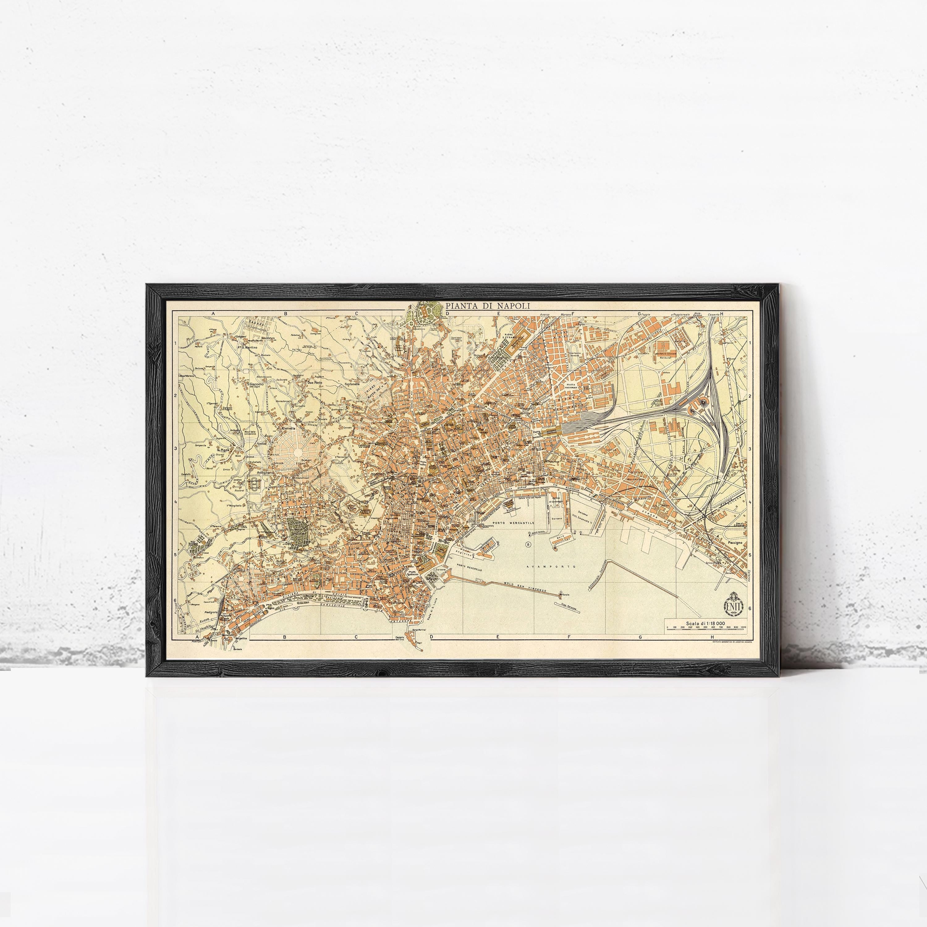 The image is a framed vintage map of a city, likely Paris, with a detailed and colorful depiction of the city's streets, landmarks, and surrounding areas.