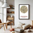 a cozy living room with a large framed map of Indianapolis hanging on the wall. The room has a wooden floor, a bookshelf filled with books, and a comfortable seating area with a chair and a teddy bear.