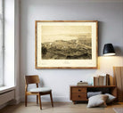The image is a framed print depicting a cityscape, likely from the 19th century, with a detailed and intricate view of the city's layout and architecture.