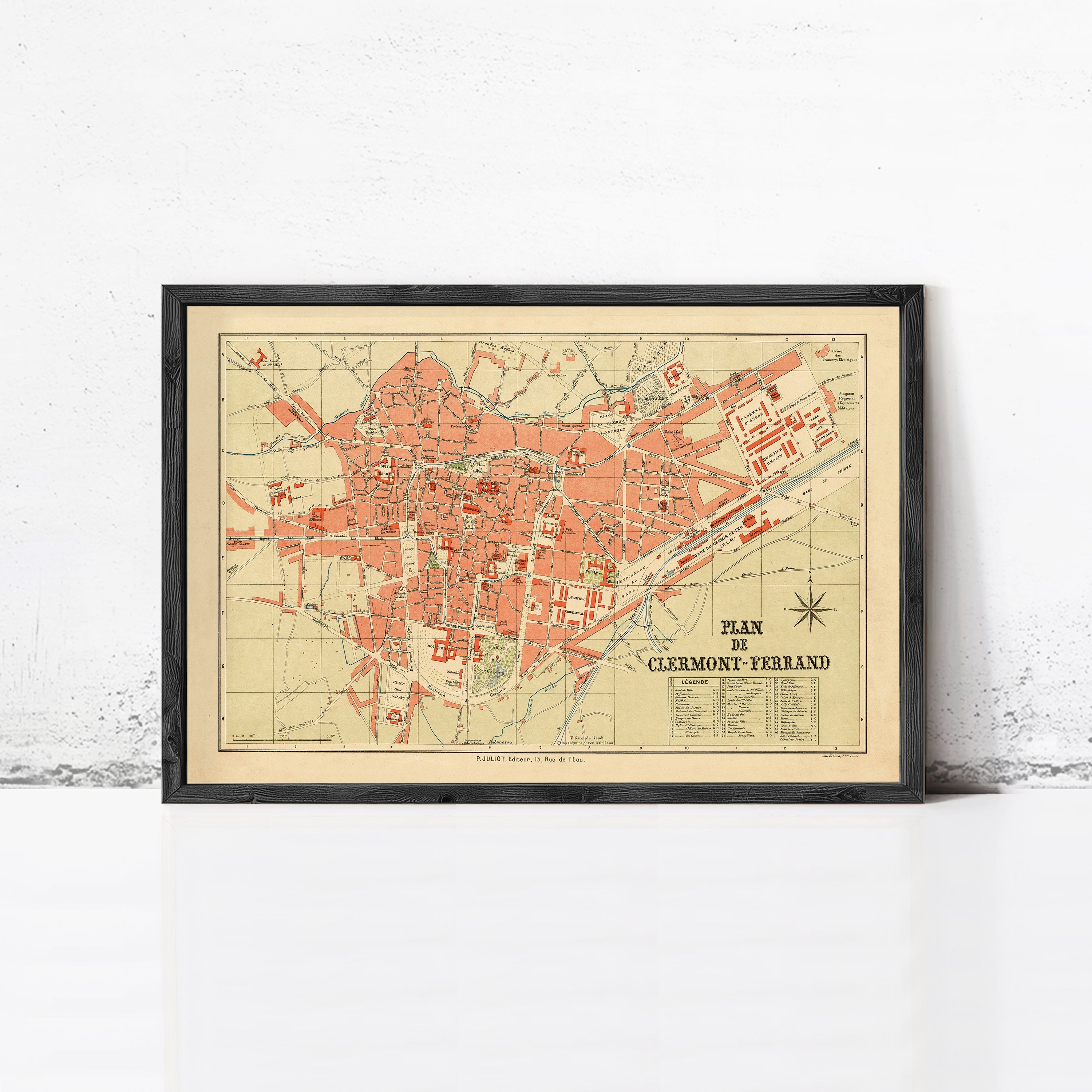 The image is a framed vintage map of the city of Clermont-Ferrand, France, depicting the layout and geographical features of the area.