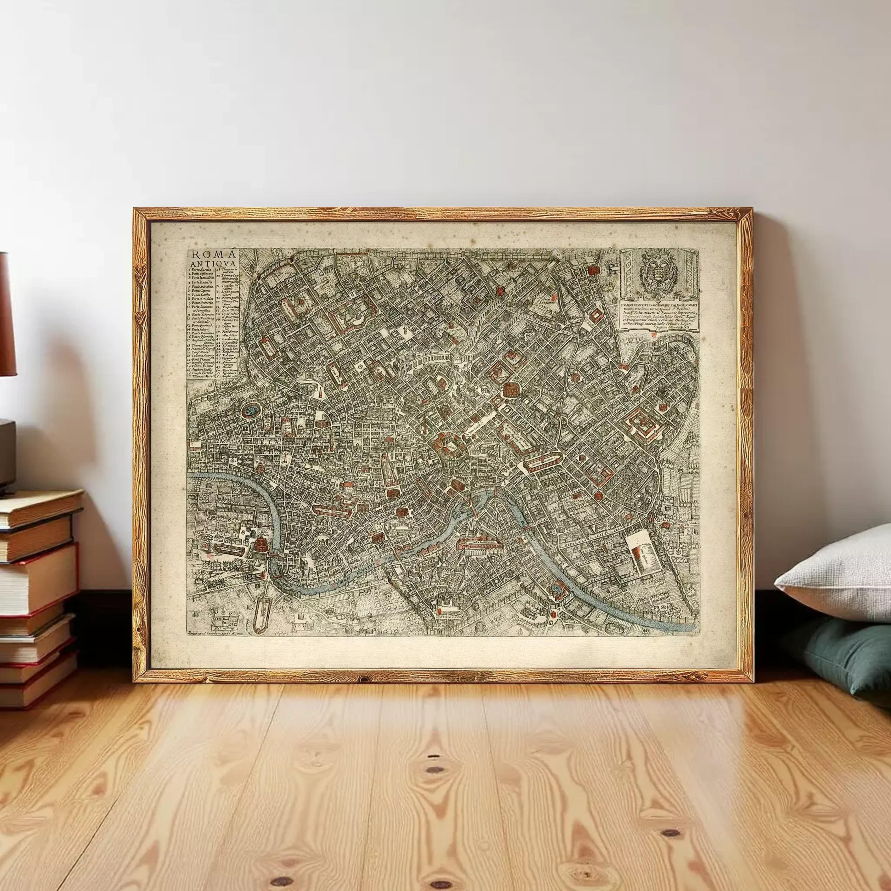 The image is a framed antique map of a city, likely from the 16th century, displayed on a white wall.