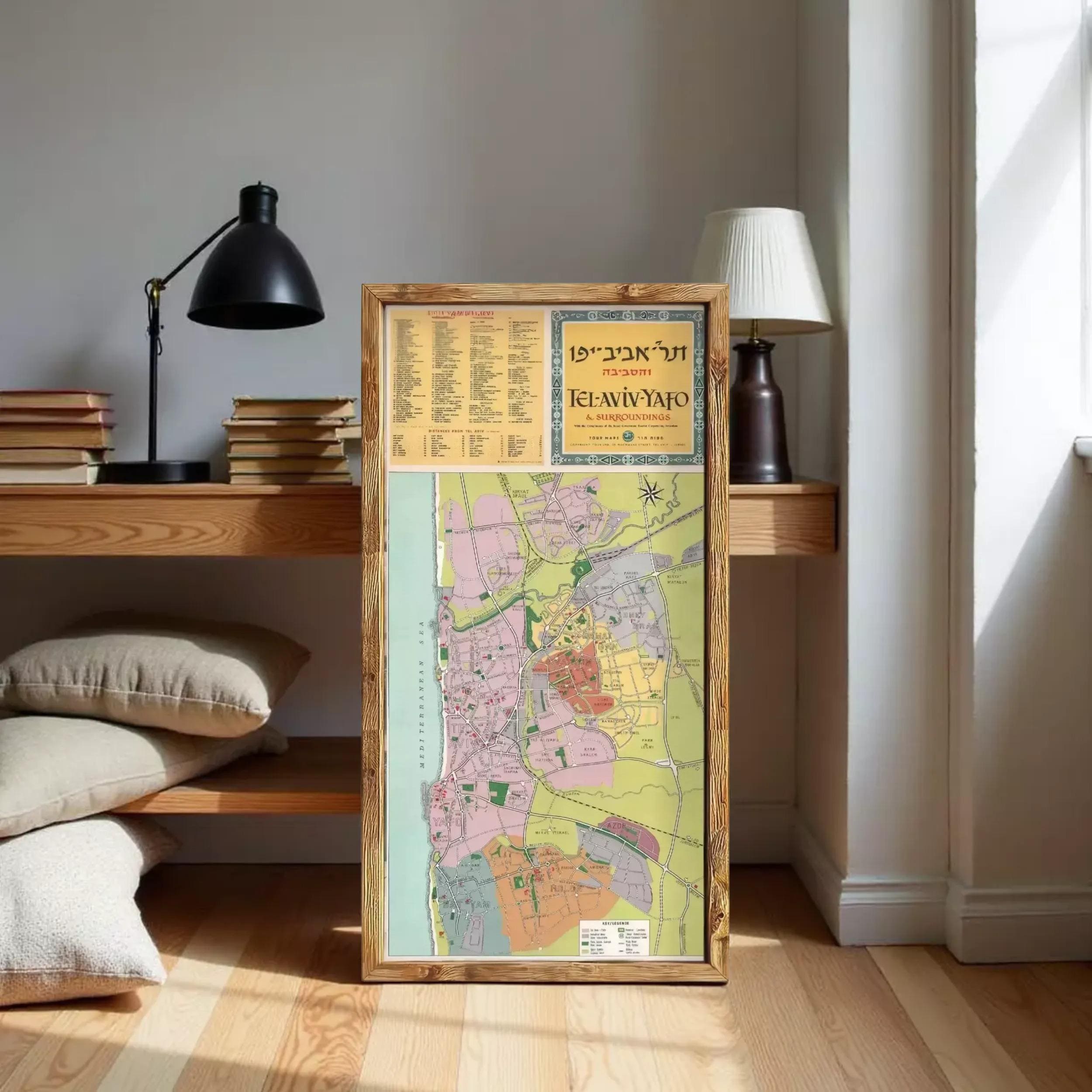 a large framed map of Tel Aviv, Israel, with a lamp and bookshelf in the background.