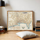 a large framed map of the city of Cannes, France, displayed on a wall.