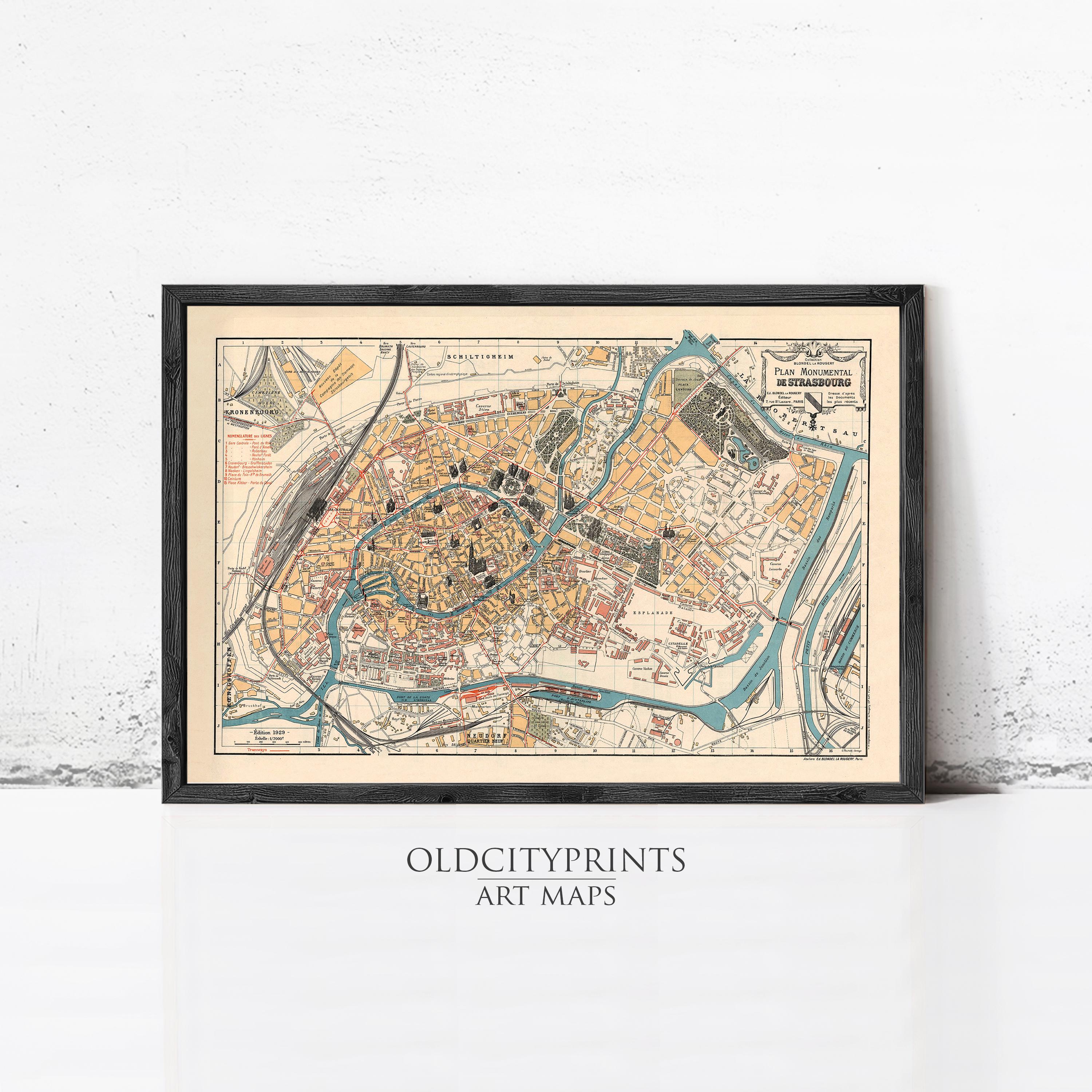The image is a framed vintage map of a city, likely from the 19th century, with detailed street and building layouts.