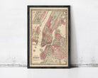 The image is a framed vintage map of New York City, depicting the city's streets and neighborhoods in a detailed and colorful manner.