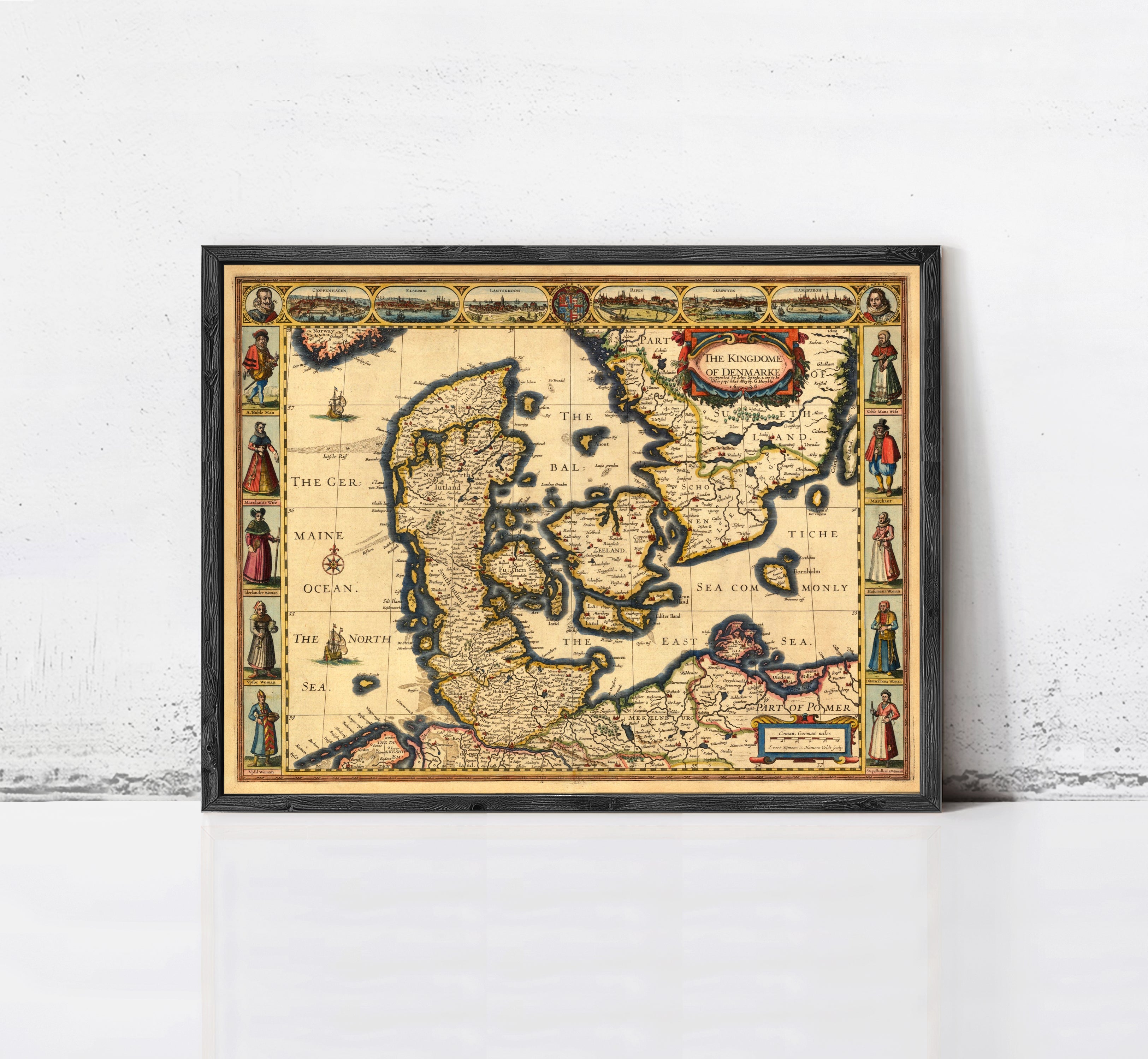 The image is a framed antique map of Europe, featuring detailed illustrations and labels.