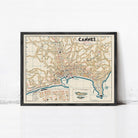 The image is a framed vintage map of the city of Cannes, France, depicting the city's streets, landmarks, and surrounding areas.