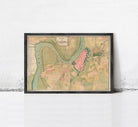 The image is a framed map of a city, depicting various landmarks and geographical features.