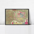 The image is a framed vintage map of a city, depicting various landmarks and streets in a colorful and detailed manner.