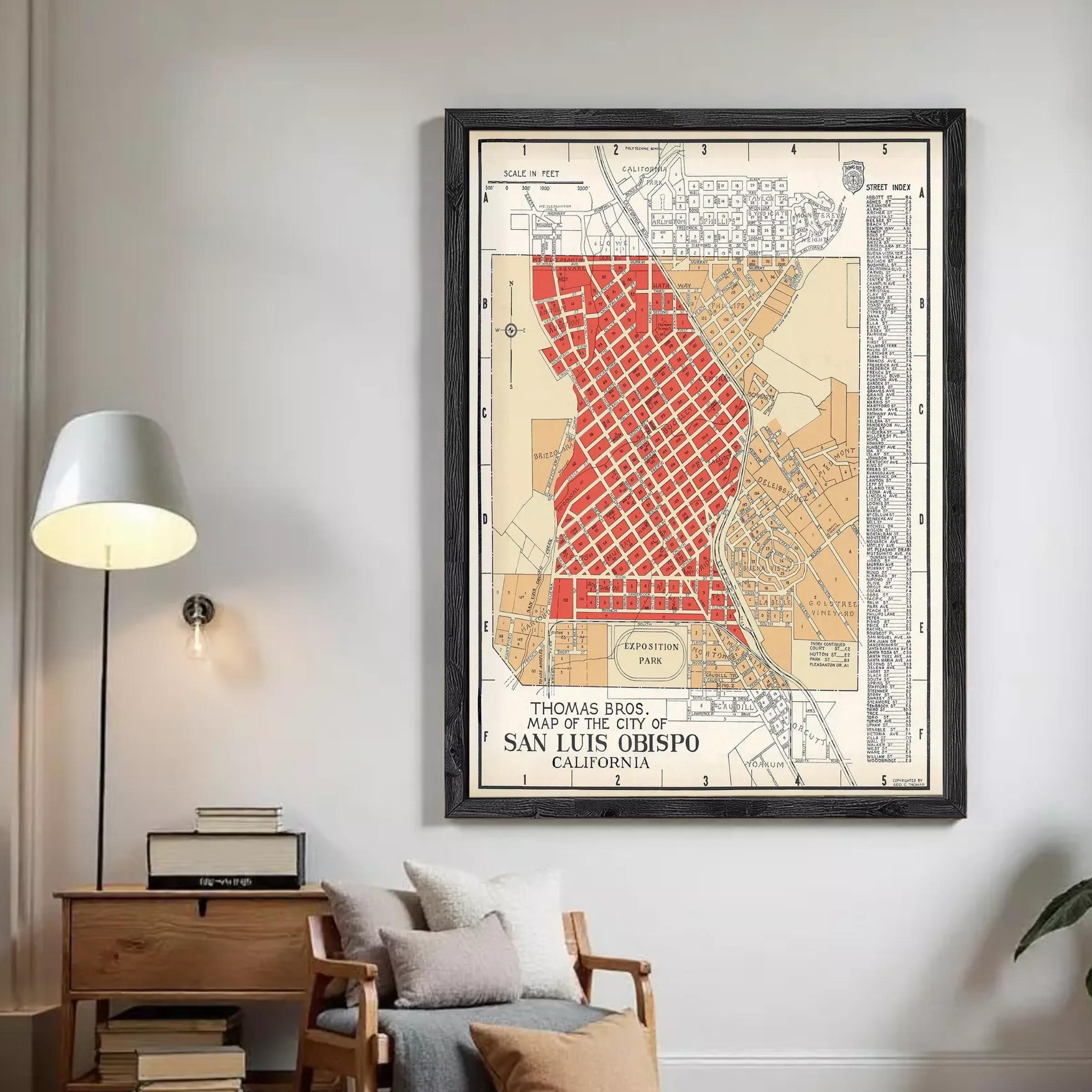 A framed vintage map of San Luis Obispo, California, depicting the city's streets and surrounding areas.