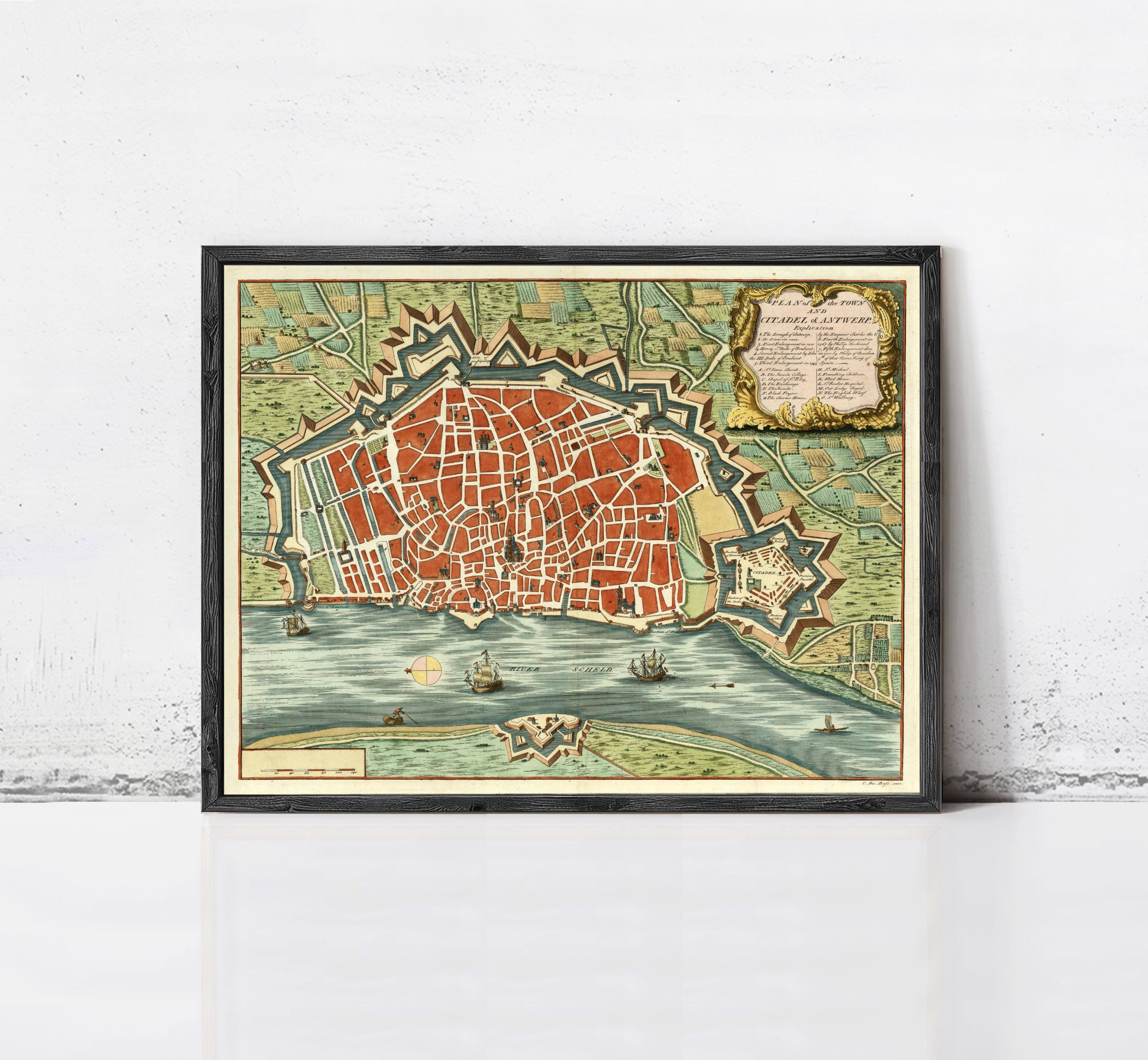 The image is a framed vintage map of a city, depicting a detailed layout of the streets, landmarks, and surrounding areas.