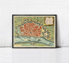 The image is a framed vintage map of a city, depicting a detailed layout of the streets, landmarks, and surrounding areas.