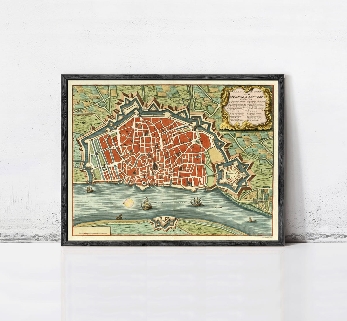 The image is a framed vintage map of a city, depicting a detailed layout of the streets, landmarks, and surrounding areas.