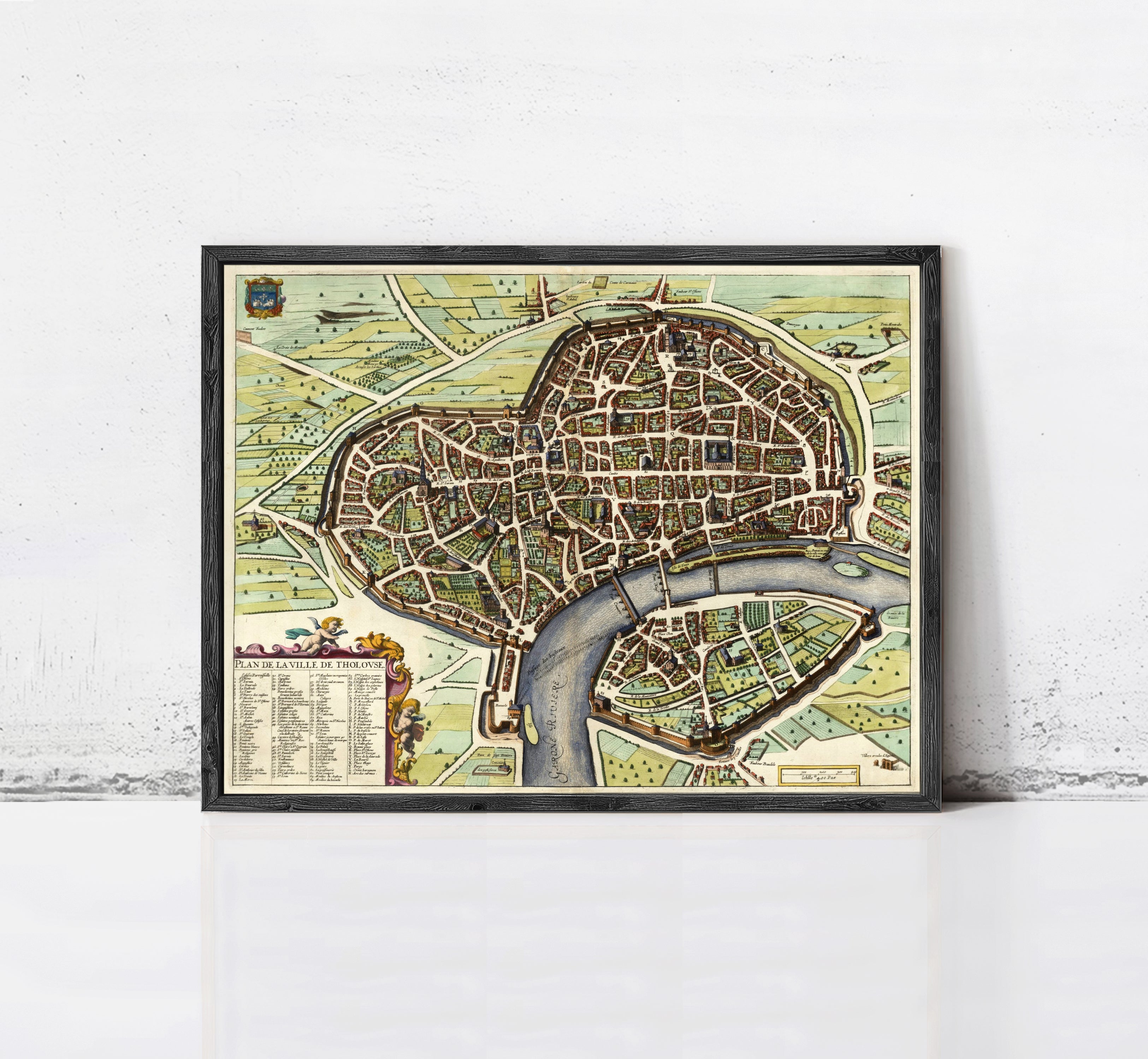 The image is a framed vintage map of a city, depicting a detailed layout of streets, buildings, and other urban features.