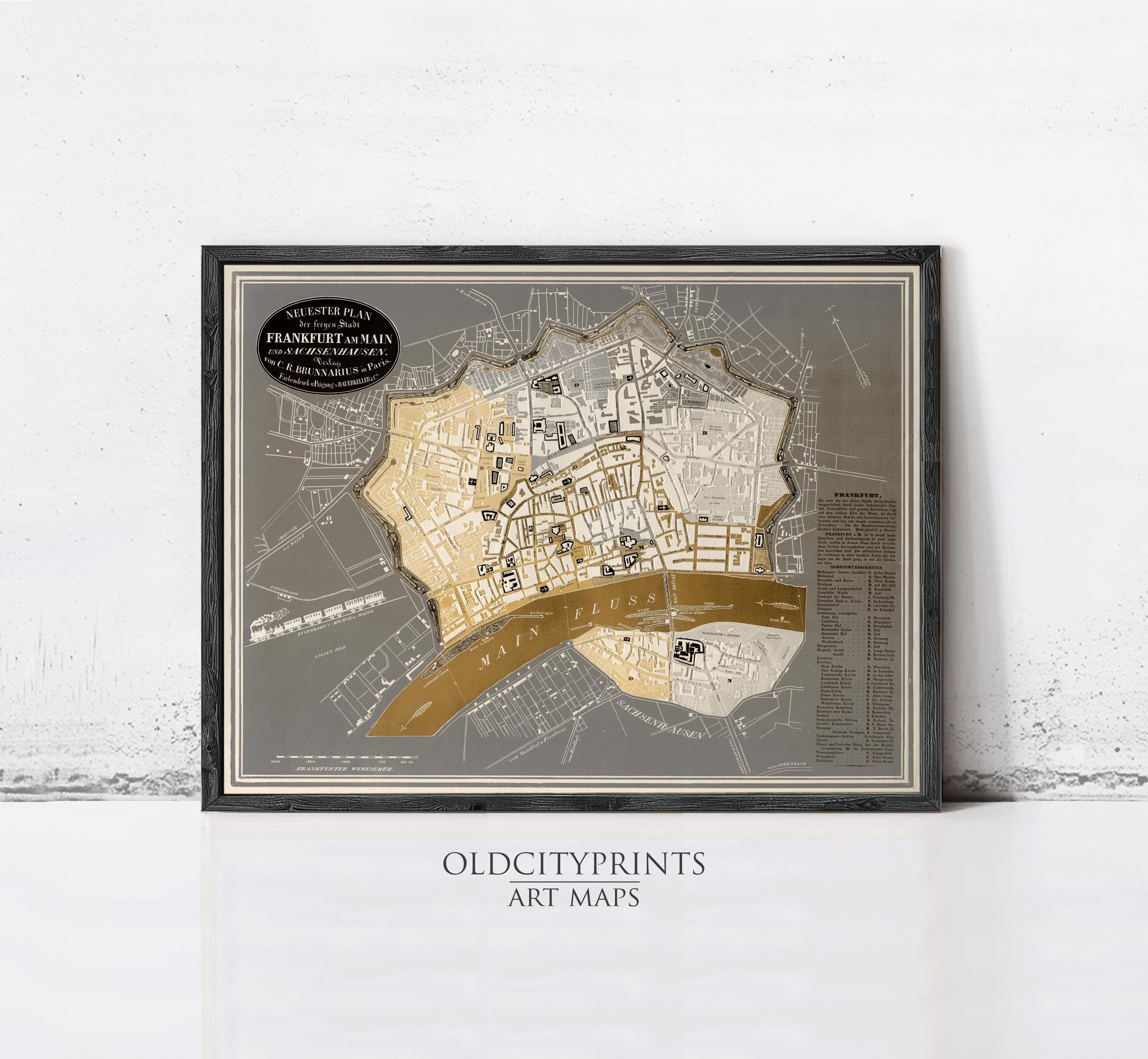 The image is a framed art print depicting a detailed map of a city, with various streets, landmarks, and other geographical features.