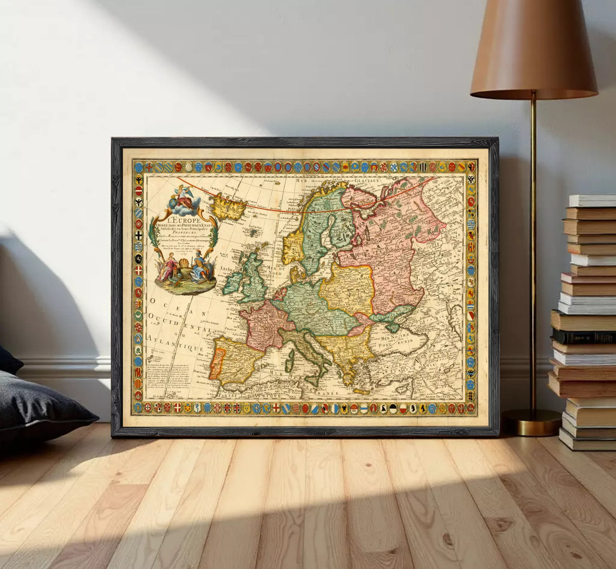 The image is a framed antique map of Europe, featuring detailed cartography and colorful borders.