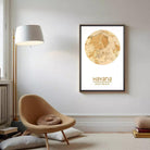 a cozy living room with a brown armchair, a floor lamp, and a framed map of Havana hanging on the wall.