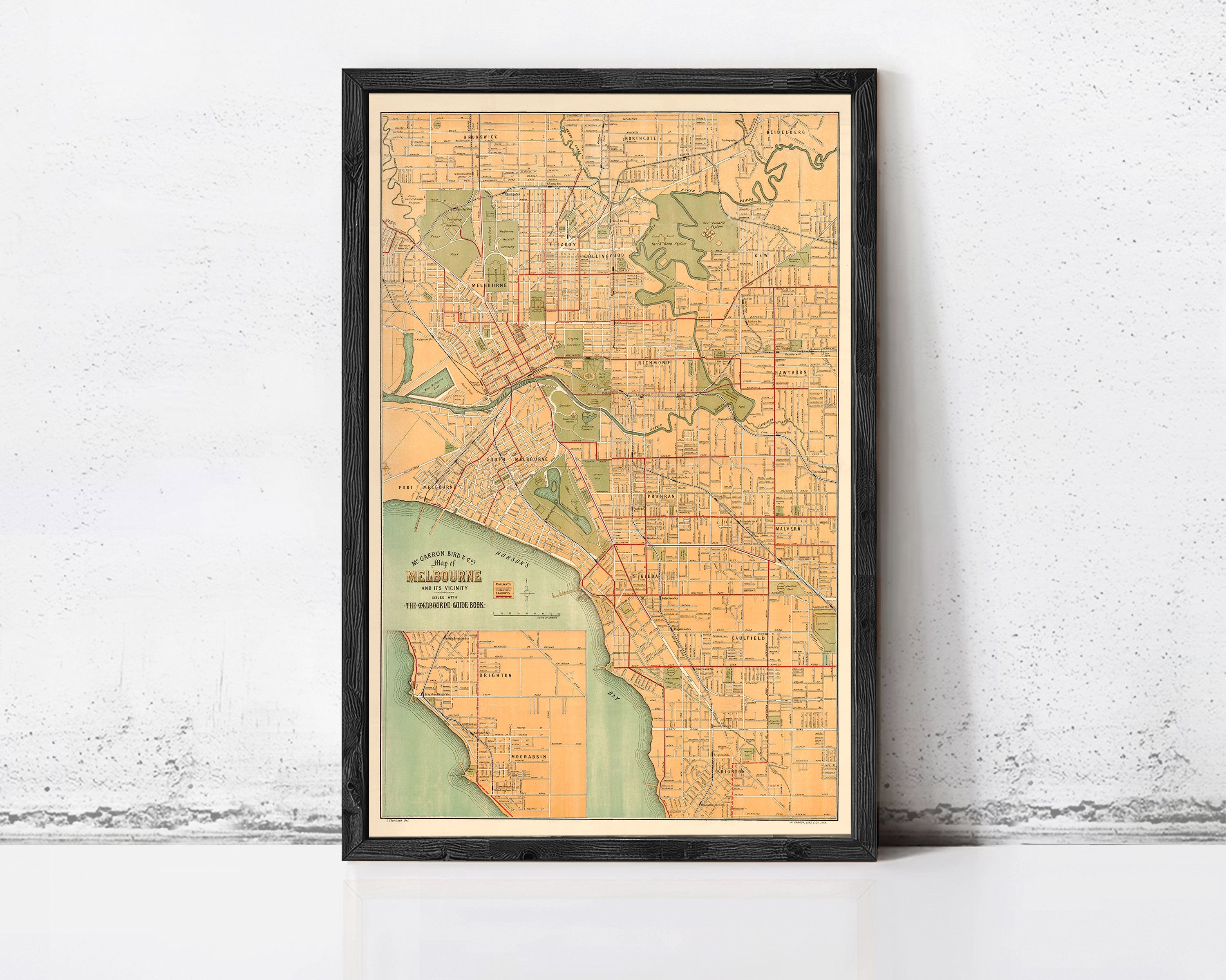 The image is a framed vintage map of Melbourne, Australia, depicting the city's streets and surrounding areas.