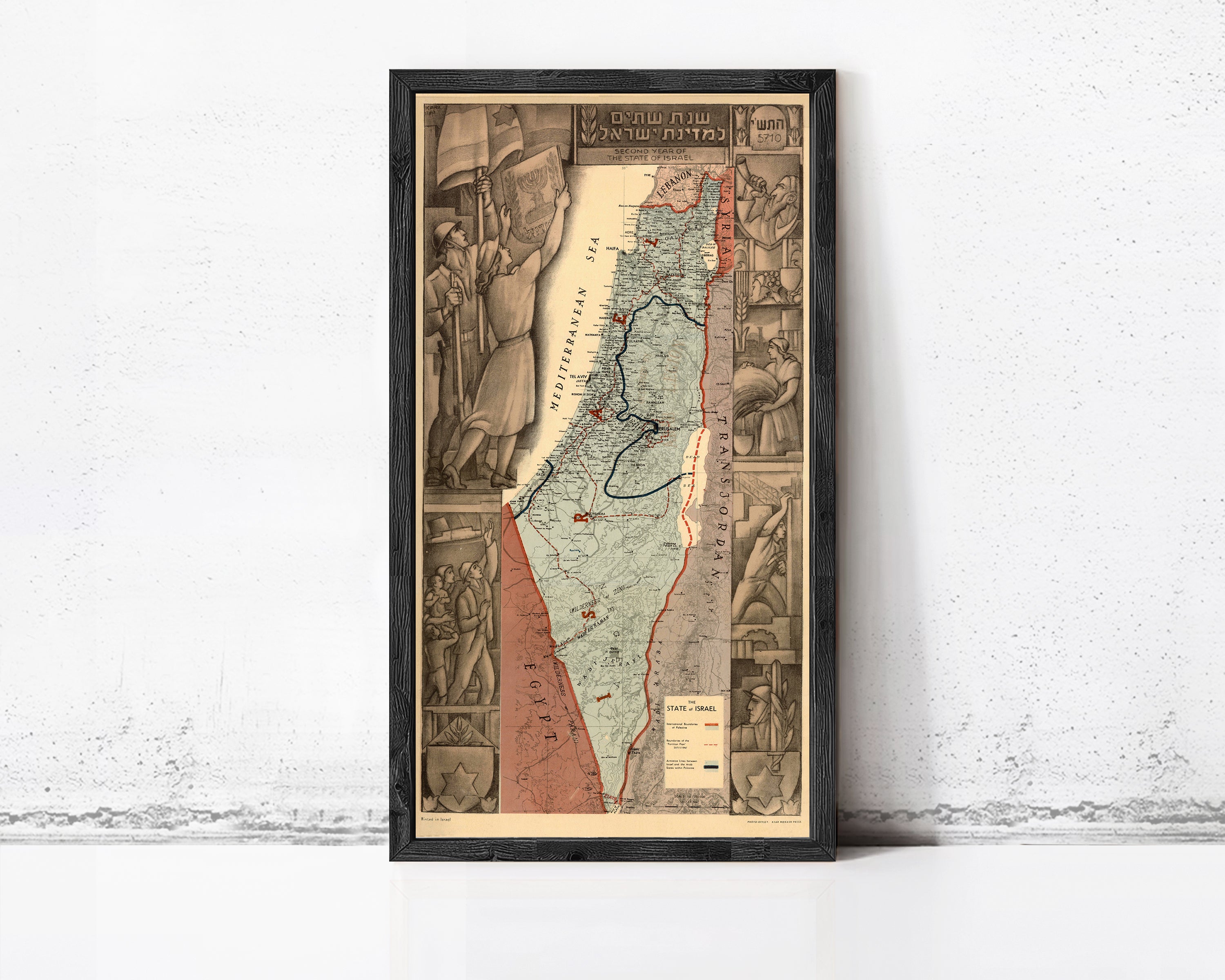 The image is a framed map of Israel, depicting the country's borders, major cities, and geographical features.