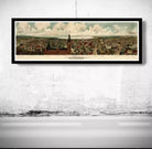 A framed painting depicting a cityscape with a tall building and a flag, hanging on a wall.