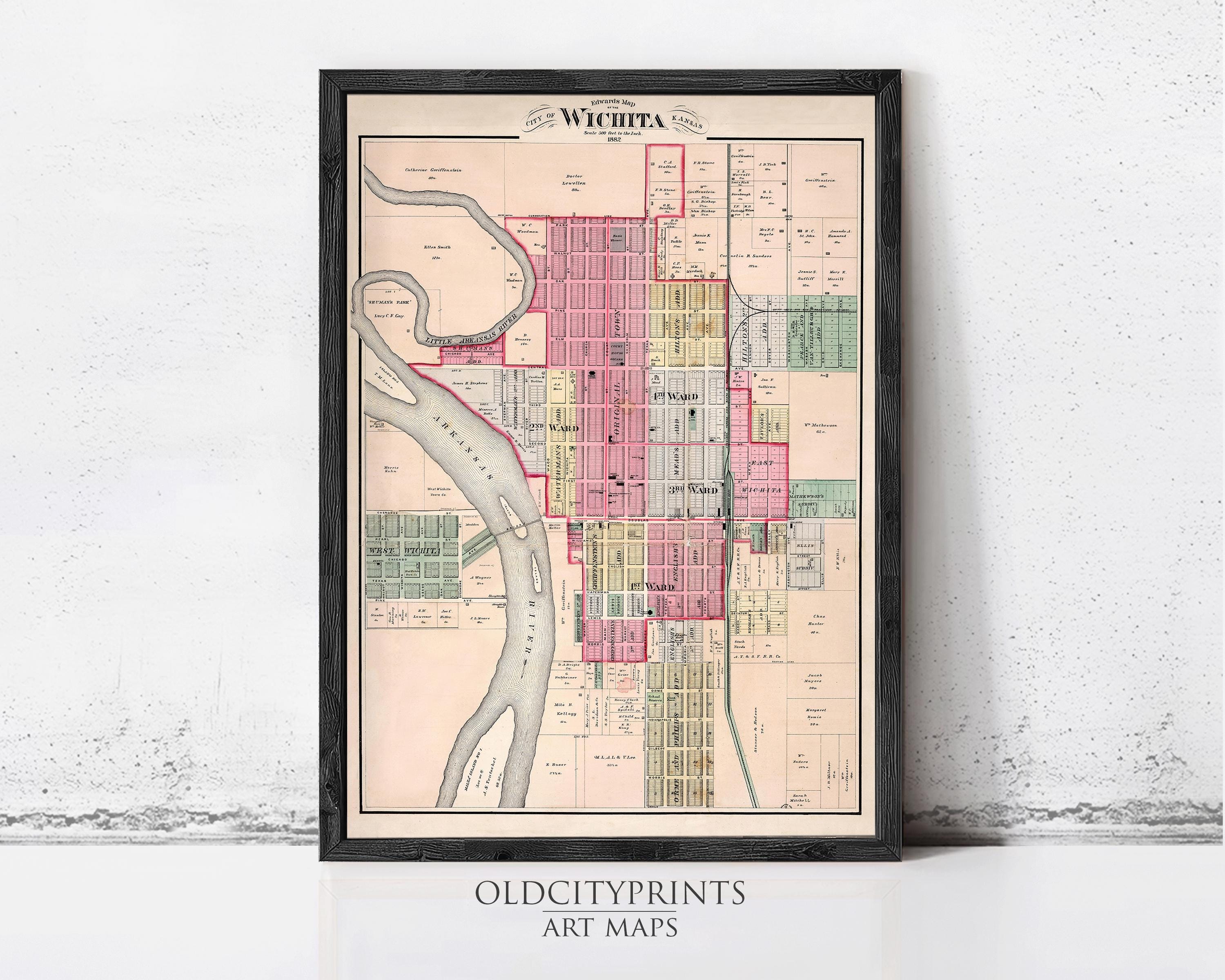 The image is a framed vintage map of the city of Wichita, Kansas, depicting the layout of the city in a detailed and colorful manner.