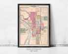The image is a framed vintage map of the city of Wichita, Kansas, depicting the layout of the city in a detailed and colorful manner.