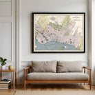 a large framed map of Montreal, Canada, hanging on a wall above a wooden bench.