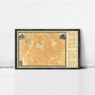 The image is a framed vintage map of a city, likely from the 19th century, displayed on a white wall.