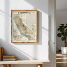 a framed map of California hanging on a white wall.