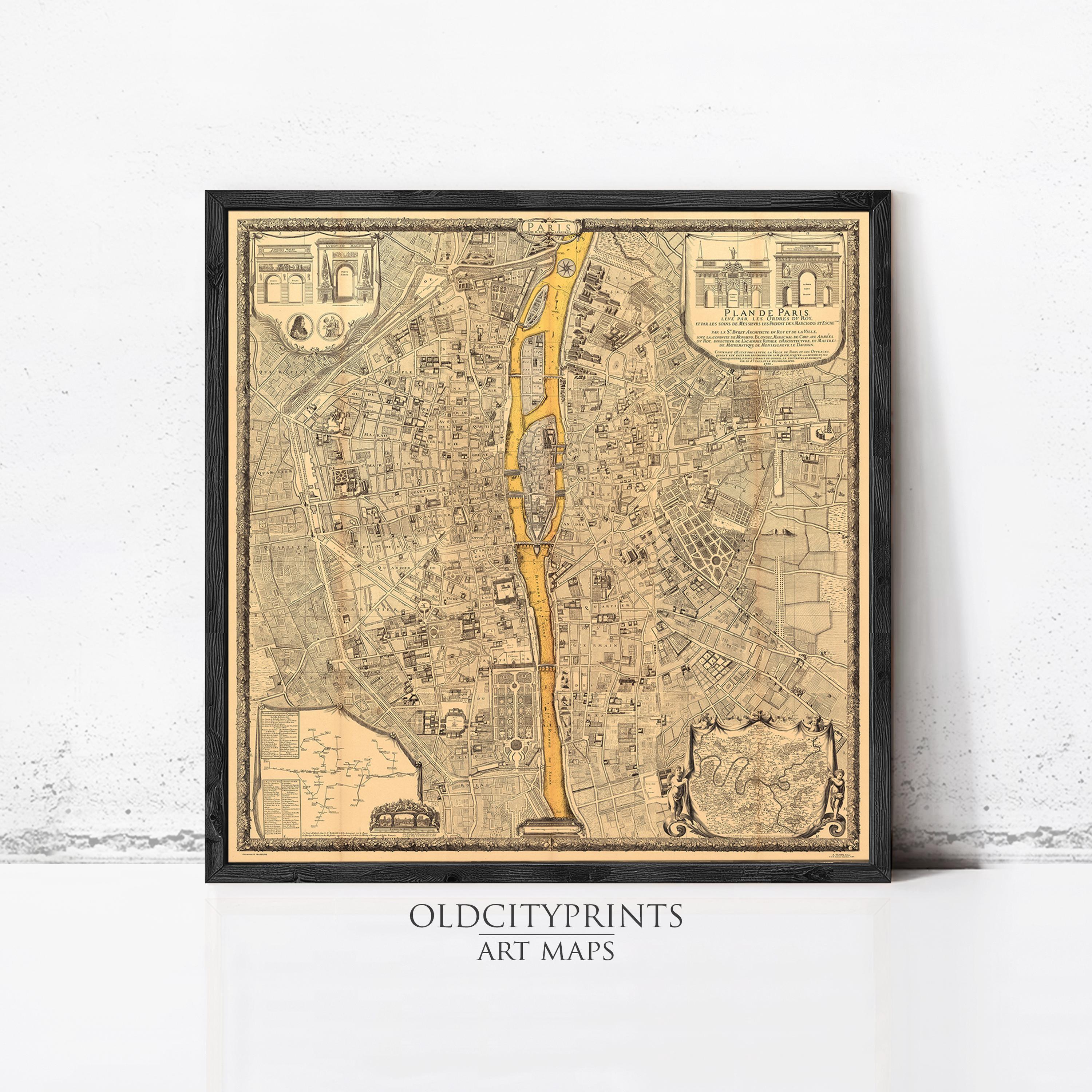 The image is a framed vintage map of a city, likely Paris, with detailed illustrations and labels.