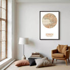 a cozy living room with a large window, a lamp, a chair, and a framed map of Zurich.