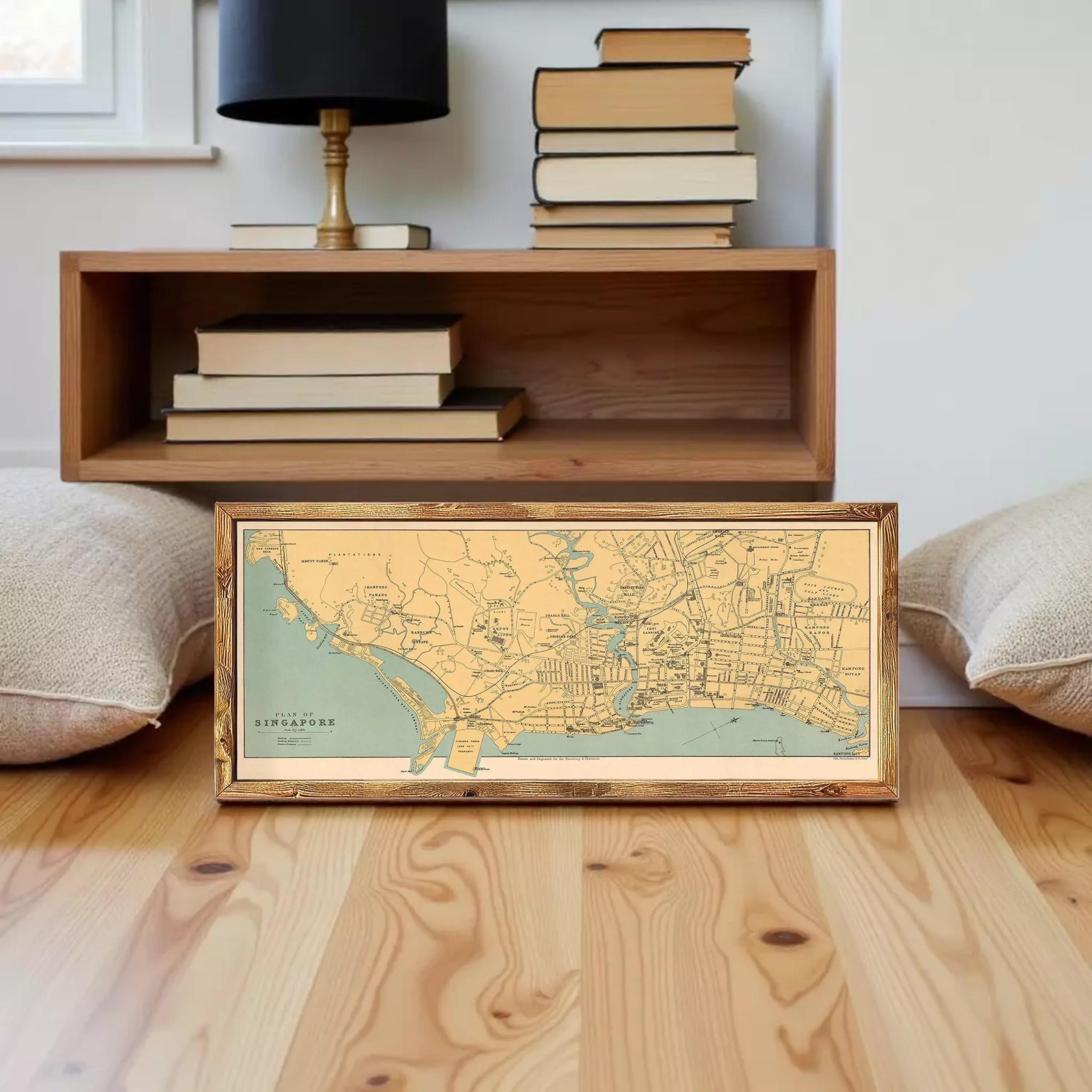 A framed map of Singapore is displayed against a white wall.