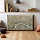 a large framed map of London, with a lamp and bookshelf in the background.