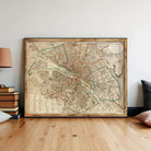 a large, framed map of Paris, France, displayed on a wall.
