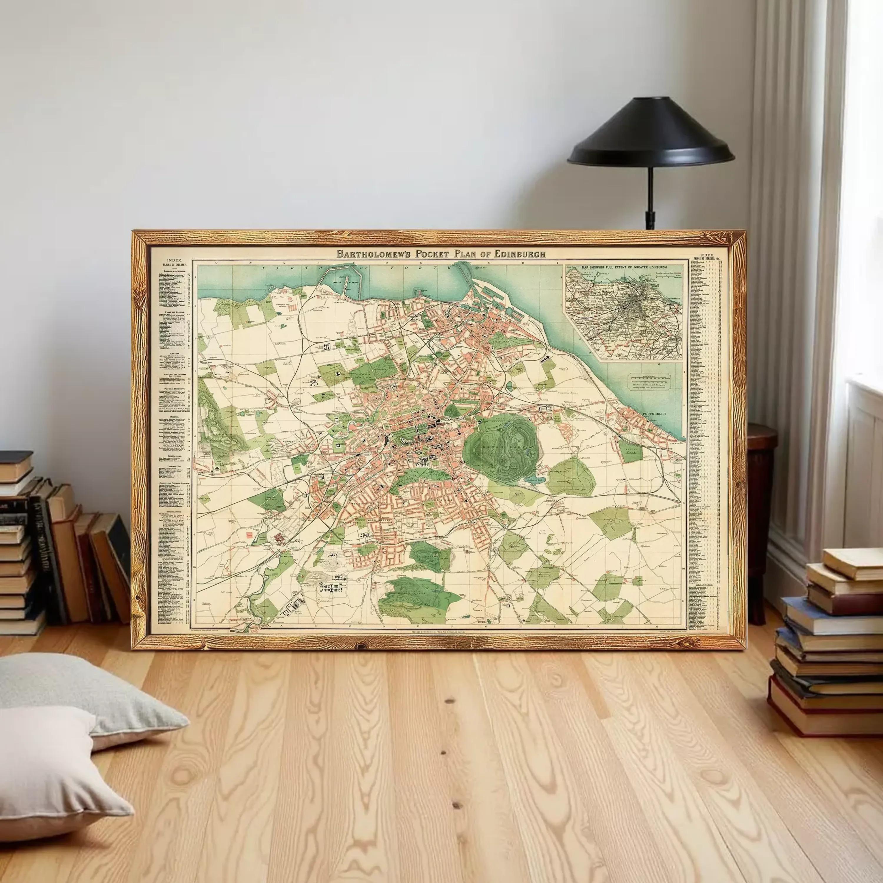 a large framed map of Edinburgh, Scotland, with a wooden floor and a stack of books in the background.