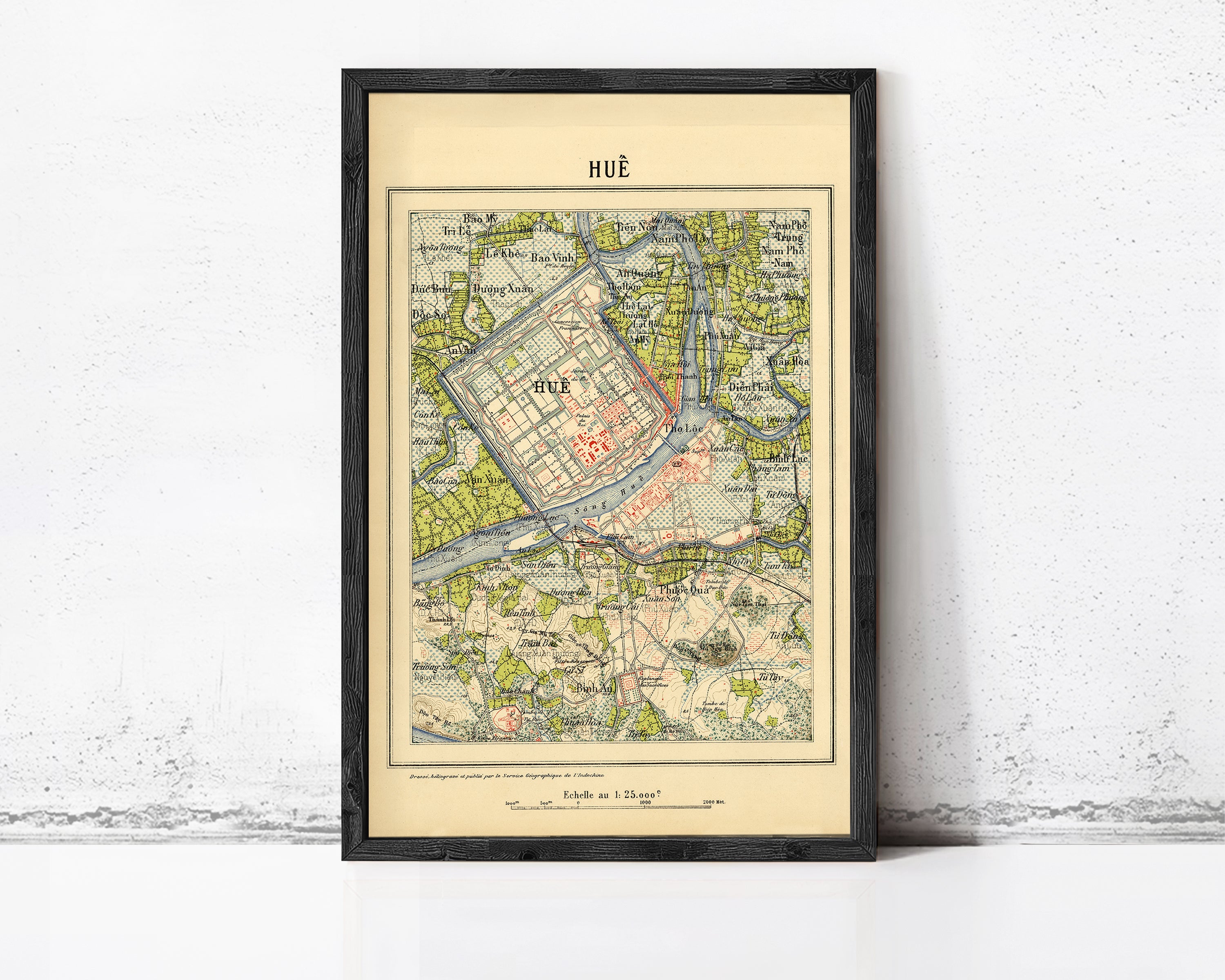 The image is a framed vintage map of Hue, Vietnam, with a black border and a beige background.