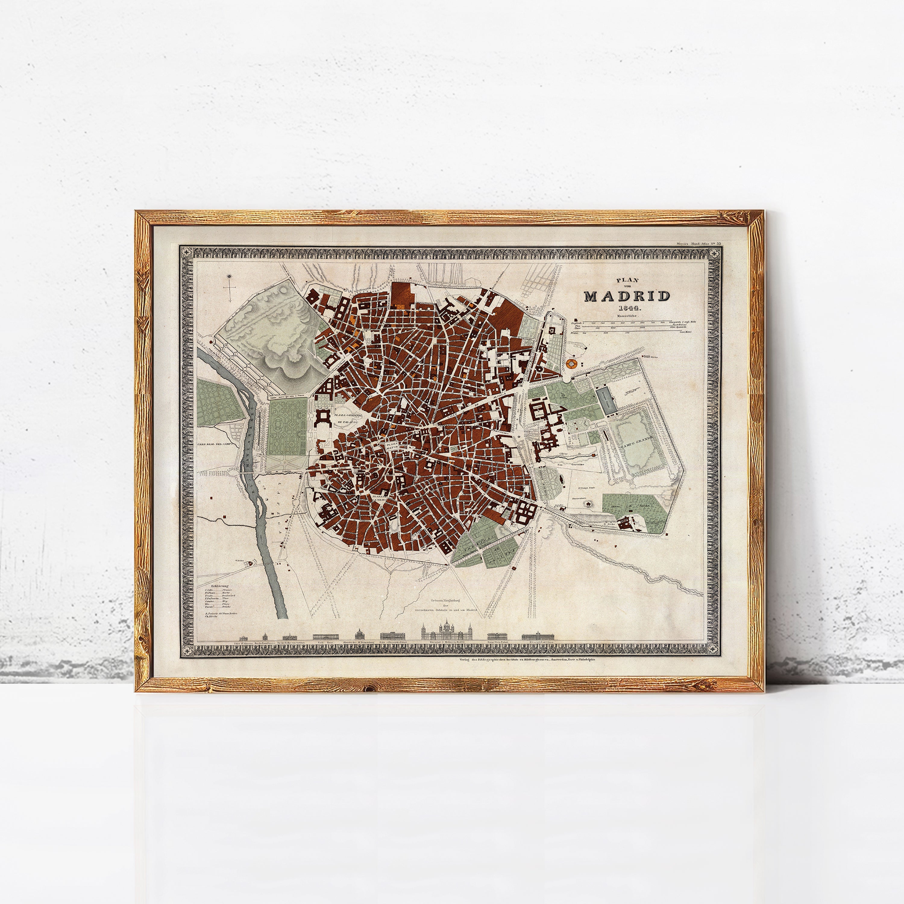 The image is a framed map of Madrid, Spain, depicting the city's layout and surrounding areas.