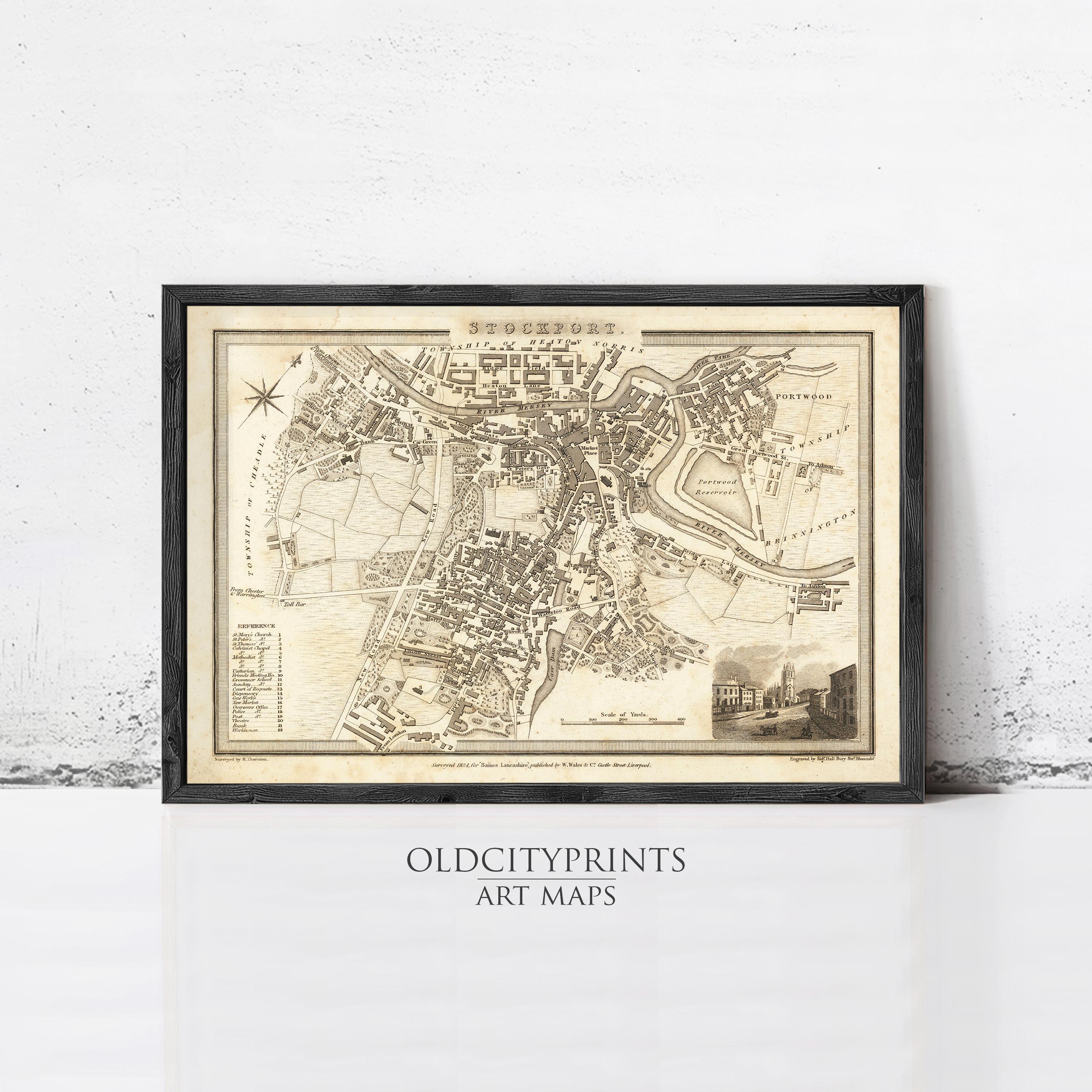 The image is a framed antique map of a city, likely from the 18th century, displayed on a wall.