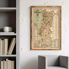 a framed map of Portugal hanging on a wall, with a bookshelf and a chair visible in the background.