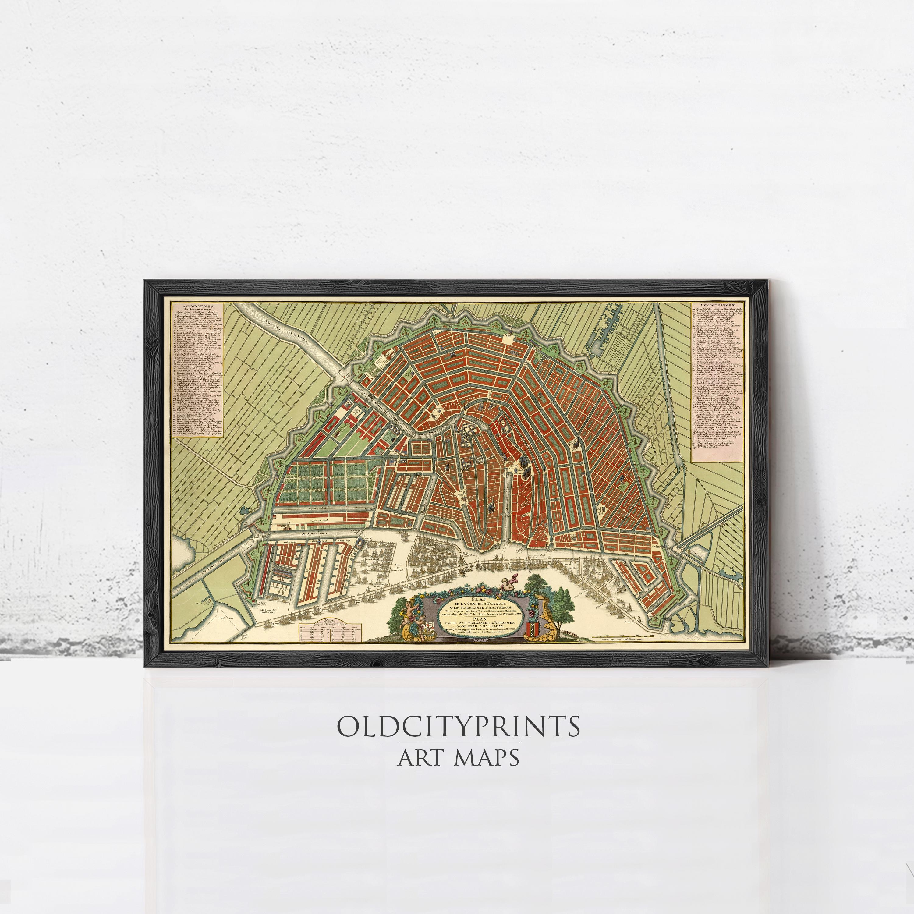 The image is a framed art print depicting a detailed map of a city, likely Amsterdam, with various streets, buildings, and landmarks.
