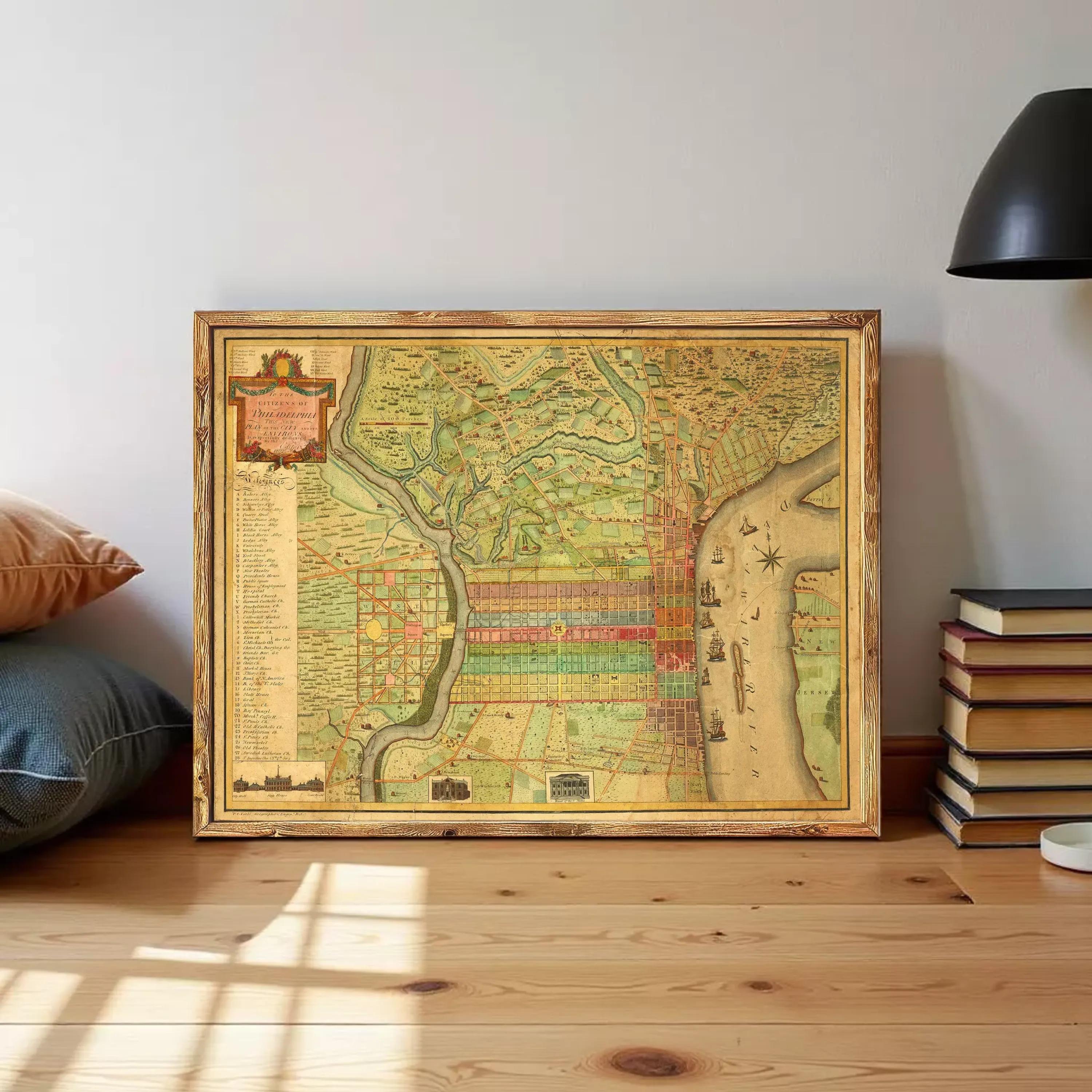 The image is a framed antique map of the city of Philadelphia, Pennsylvania, with a detailed and colorful depiction of the city's streets, landmarks, and waterways.