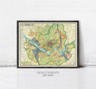 The image is a framed art print depicting a detailed map of a city or region, with various colored lines and symbols representing roads, rivers, and other geographical features.