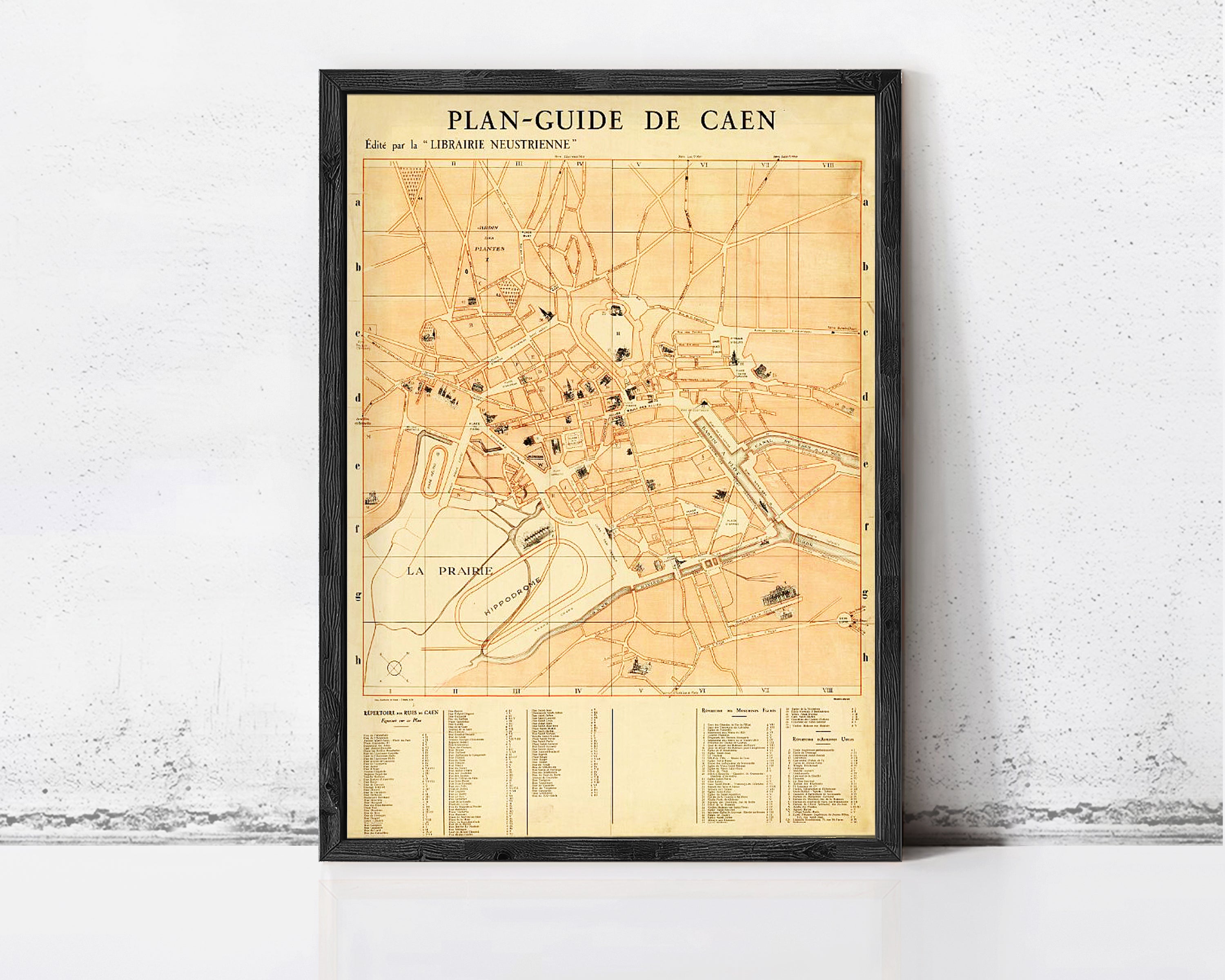 The image is a framed vintage map of Caen, France, depicting the city's layout and surrounding areas.