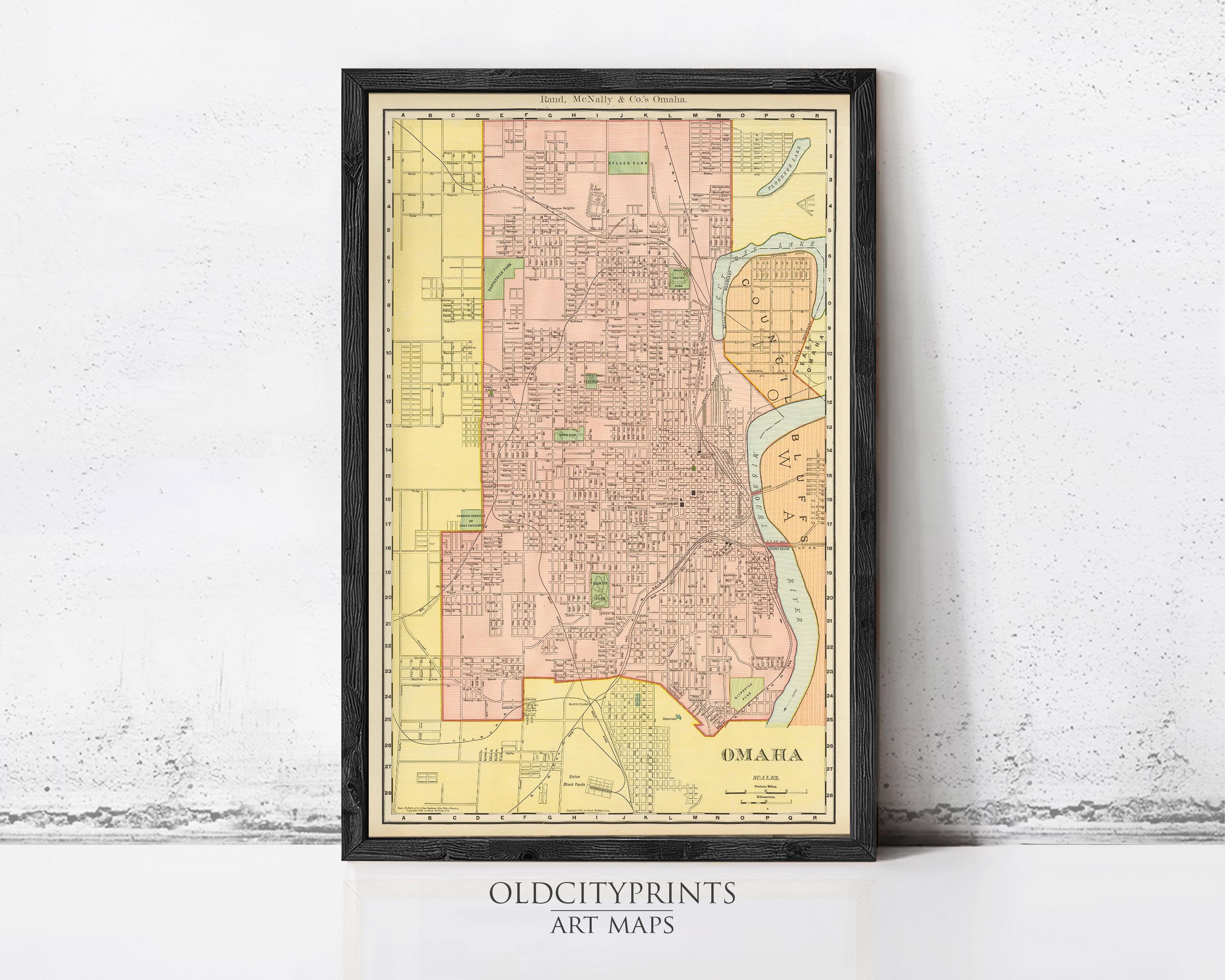The image is a framed vintage map of Omaha, Nebraska, with a black border and a yellow and red color scheme.