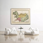 a large framed map of Iceland hanging on a white wall, with two white bean bag chairs positioned in front of it.
