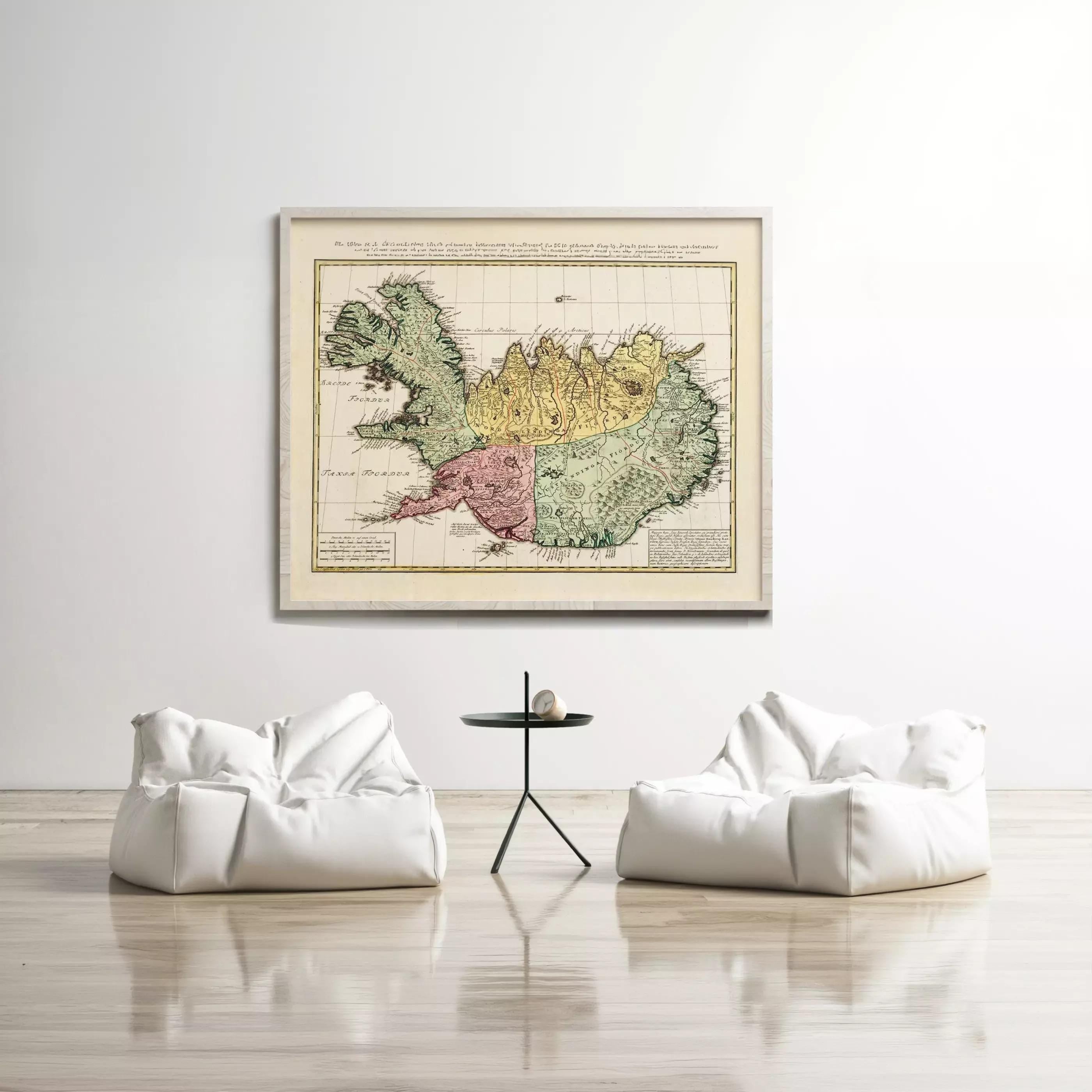 a large framed map of Iceland hanging on a white wall, with two white bean bag chairs positioned in front of it.
