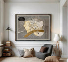 The image is a framed map of a city, likely a vintage or historical map, displayed on a wall.