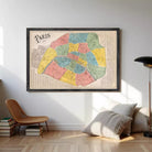 The image is a framed vintage map of Paris, France, depicting the city in a colorful and detailed manner.