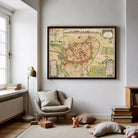 a large framed map of a city hanging on a wall in a cozy living room.